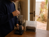 Bobby's Coffee bag on a kitchen bench while coffee is brewed with an AeroPress