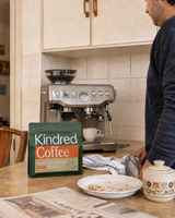 Kindred Inzovu coffee bag beside a Breville Barista Express as espresso pours into a cup