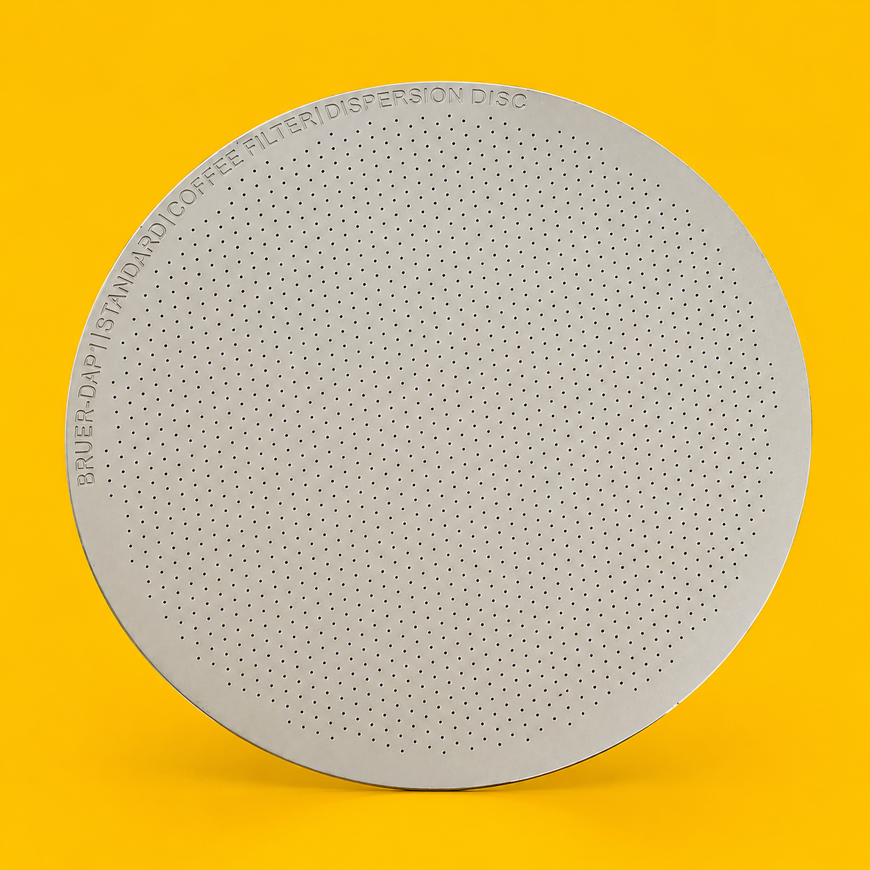 Bruer stainless steel metal disc coffee filter, Standard, on a yellow background